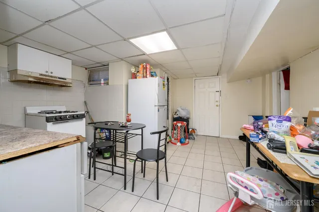 a living room with furniture a rug and a chair