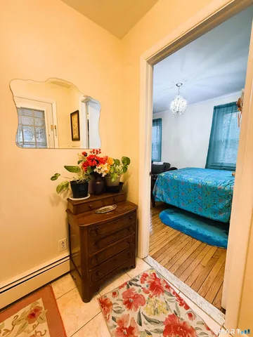 a living room with a bed and a dresser