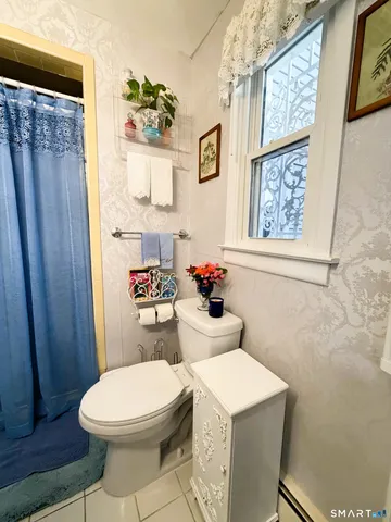 a bathroom with a toilet a sink and a shower