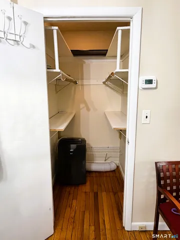 a view of walk in closet with clothes and shoes
