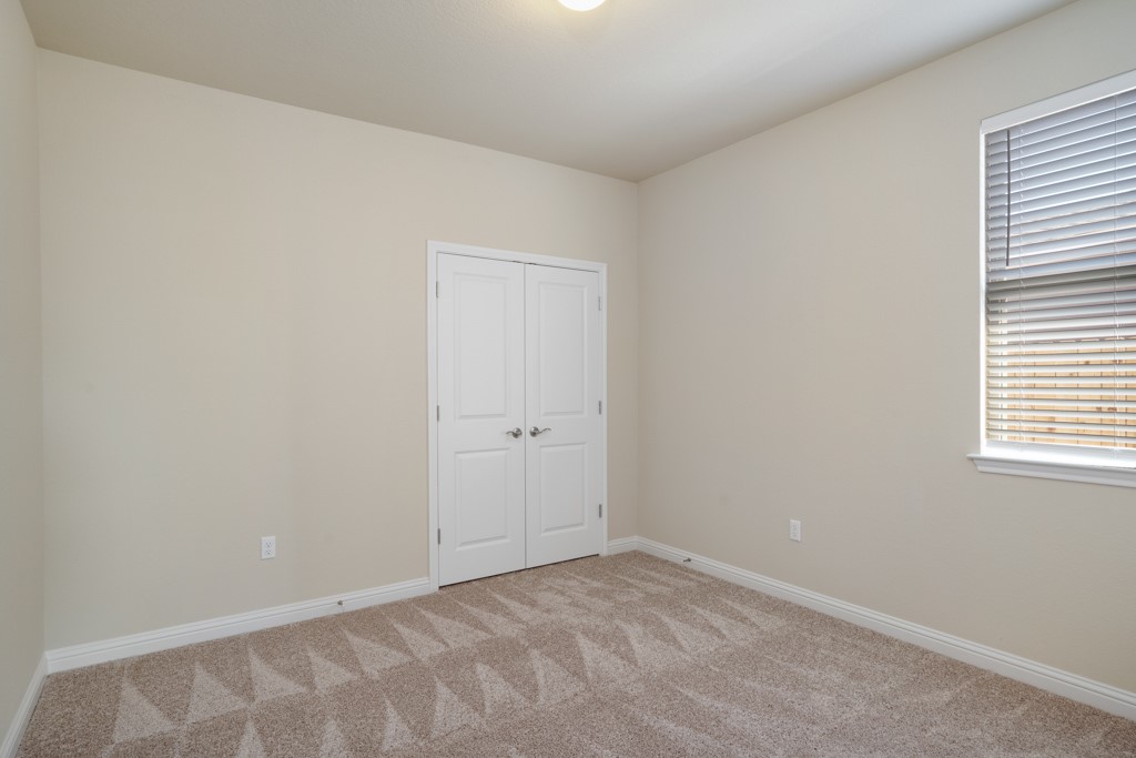 8202 Dampton Lane Austin, TX 78744 - Photo 18 of 25 a view of an empty room and a window