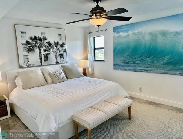 a bedroom with a bed and a painting on the wall