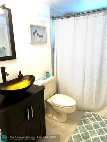 a bathroom with a granite countertop toilet sink and bathtub