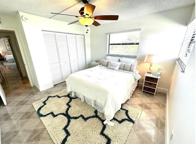 a bedroom with a bed dresser and a window