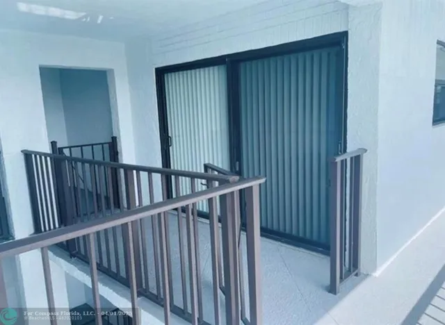 a view of a floor to ceiling window and wooden floor