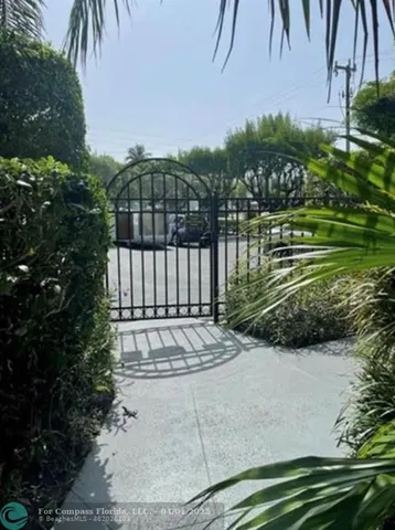 an aerial view of multi story residential apartment building with a yard and outdoor seating