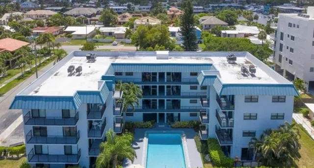 an aerial view of residential house with outdoor space and swimming pool