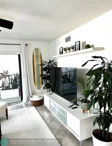 a living room with furniture and a mirror