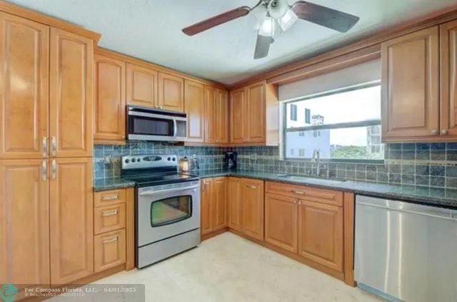 a kitchen with stainless steel appliances granite countertop a stove sink and microwave