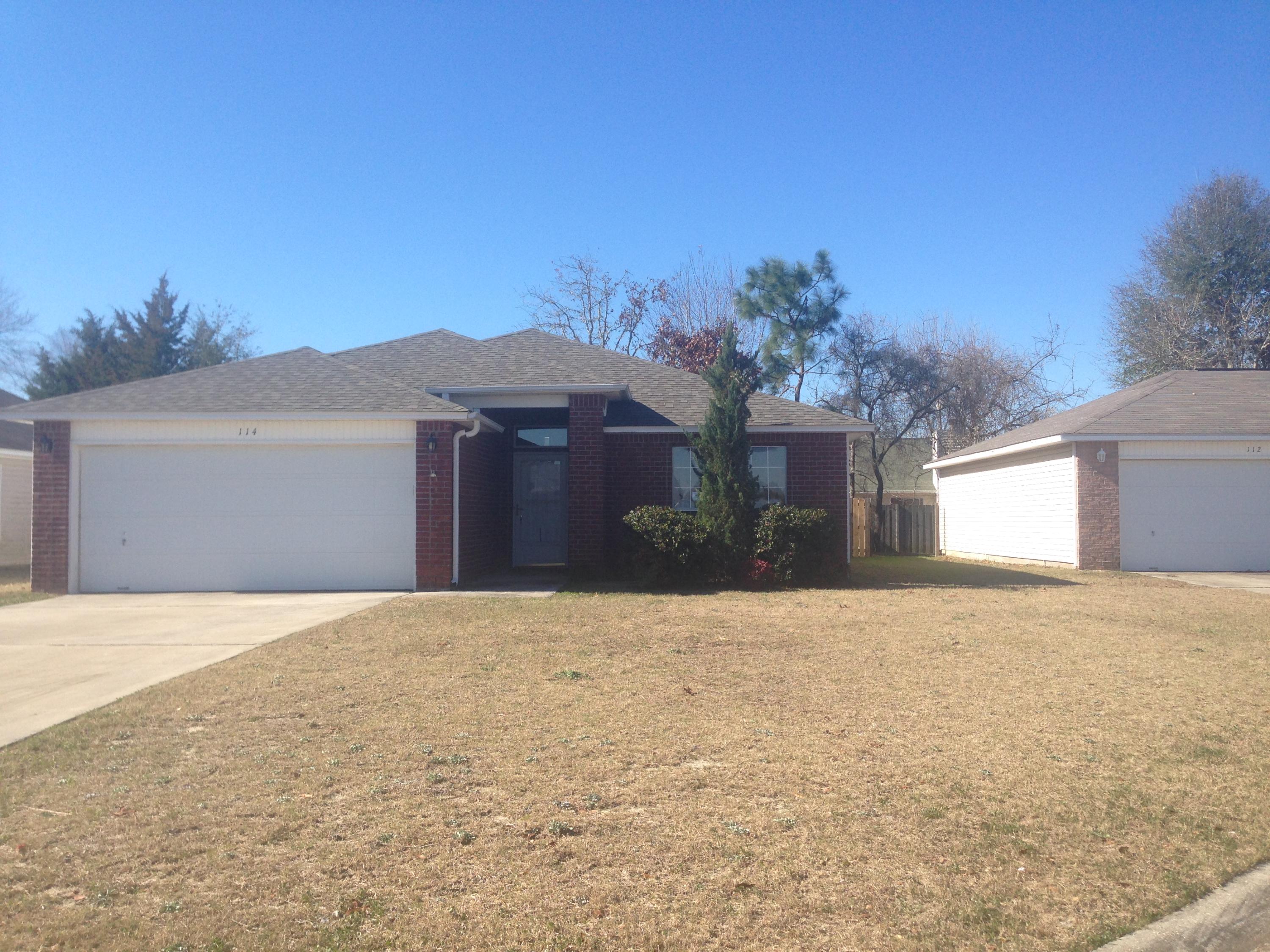 114 Sandstone Trail Crestview, FL 32539 - Photo 1 of 15 a front view of a house with a yard and garage