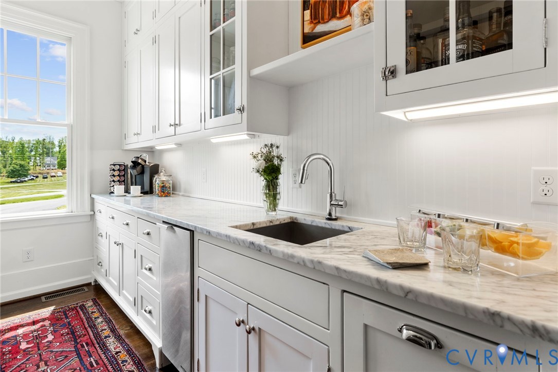 3264 Three Bridge Road Powhatan, VA 23139 - Photo 19 of 78 a kitchen with stainless steel appliances granite countertop a sink and dishwasher with wooden floor