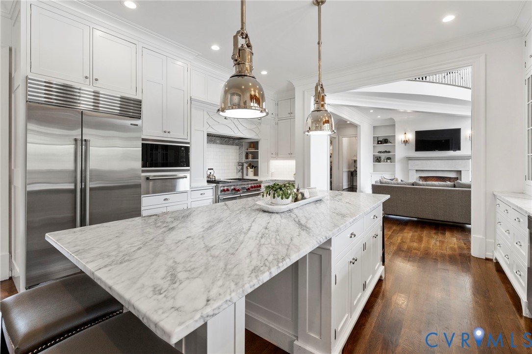 3264 Three Bridge Road Powhatan, VA 23139 - Photo 22 of 78 a kitchen with stainless steel appliances granite countertop a sink a stove and a refrigerator