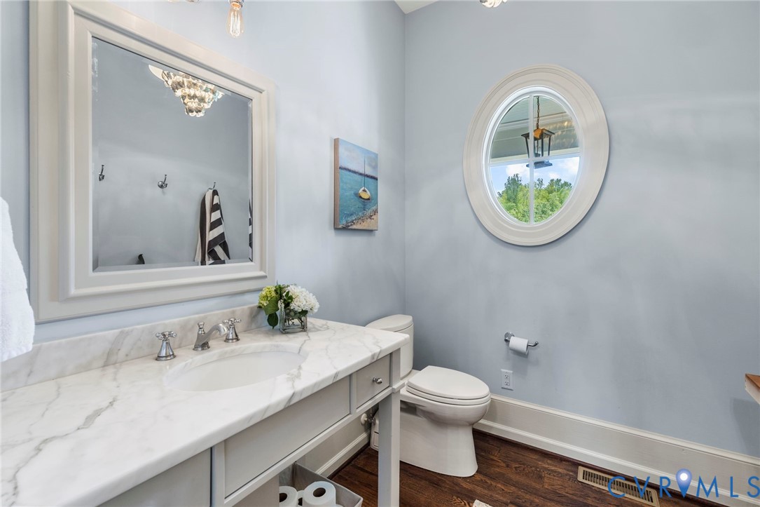 3264 Three Bridge Road Powhatan, VA 23139 - Photo 31 of 78 a bathroom with a toilet a sink and a mirror