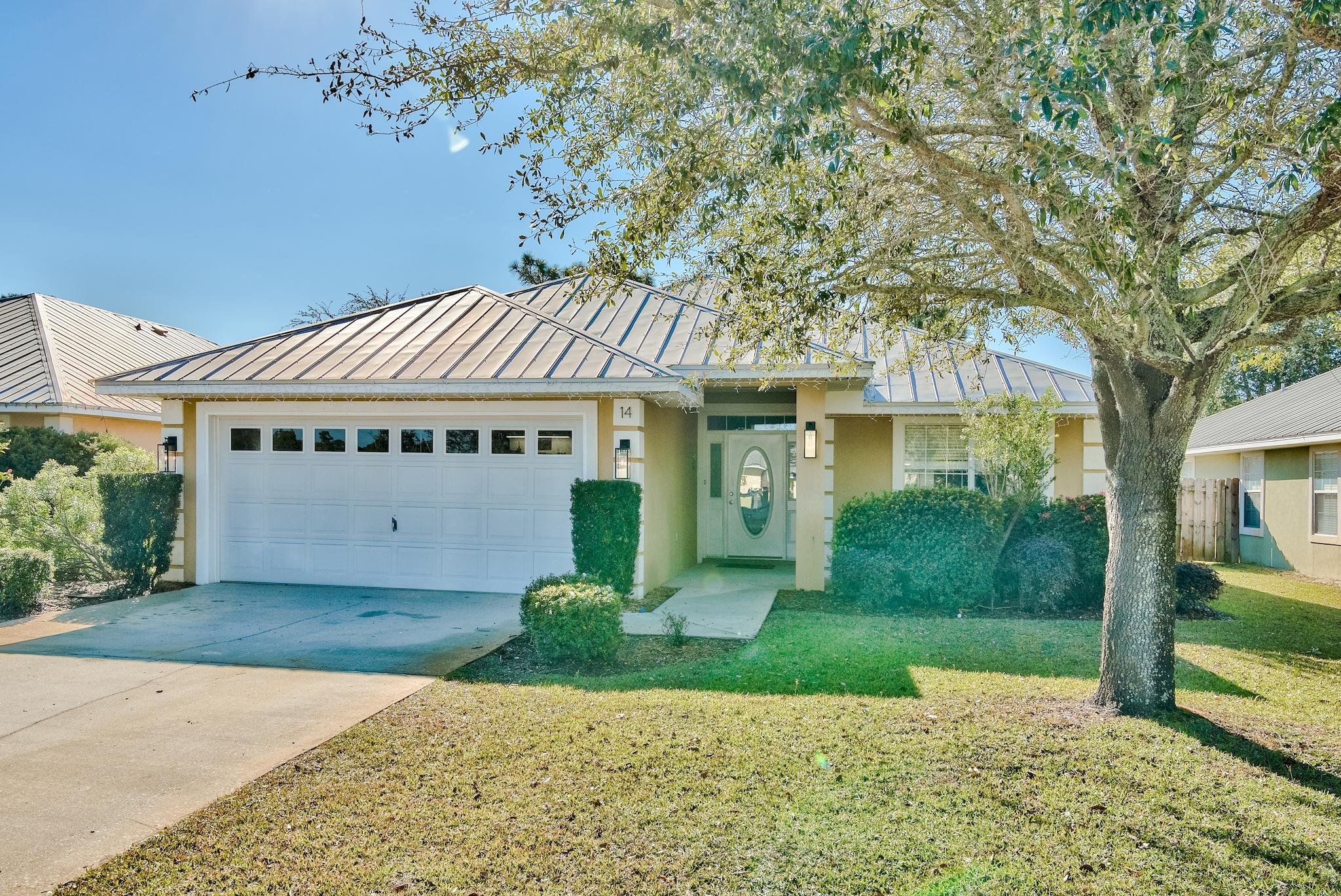 14 East Poplar Way Santa Rosa Beach, FL 32459 - Photo 1 of 30 a front view of a house with garden