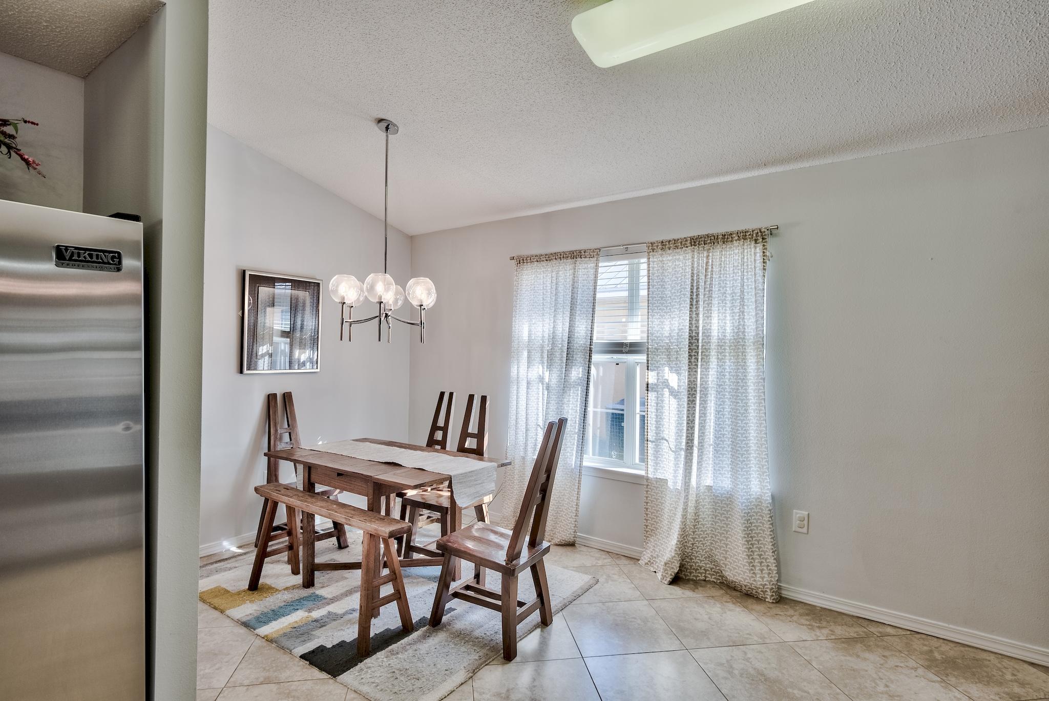 14 East Poplar Way Santa Rosa Beach, FL 32459 - Photo 11 of 30 a view of a dining room with furniture and chandelier