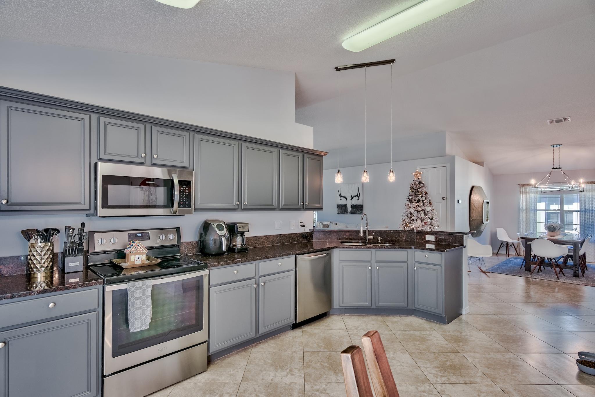 14 East Poplar Way Santa Rosa Beach, FL 32459 - Photo 13 of 30 a kitchen with stainless steel appliances granite countertop a sink and cabinets