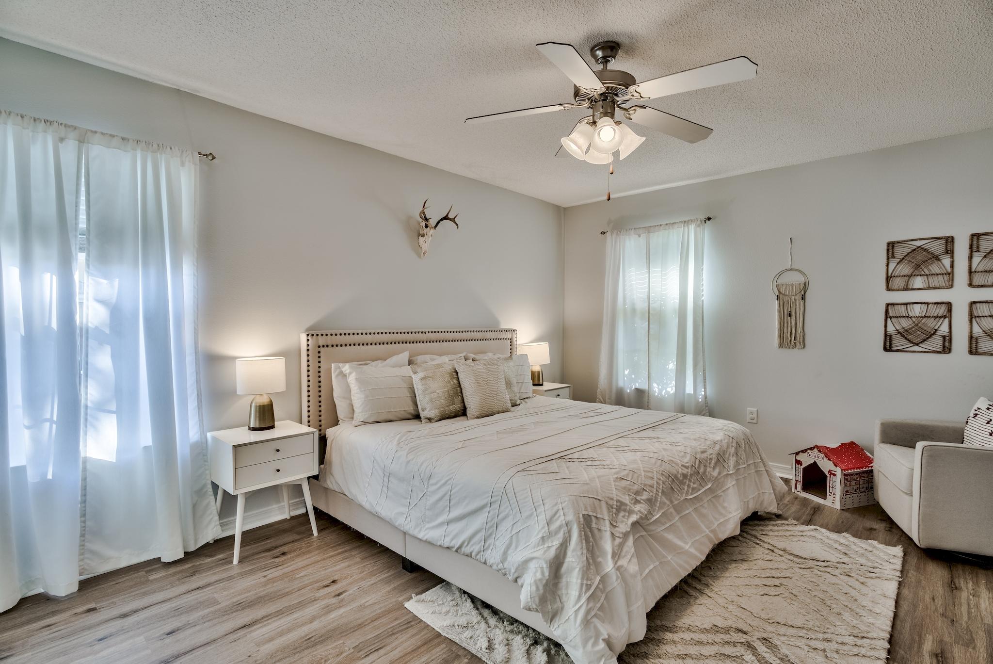 14 East Poplar Way Santa Rosa Beach, FL 32459 - Photo 15 of 30 a bedroom with a large bed chandelier and a window