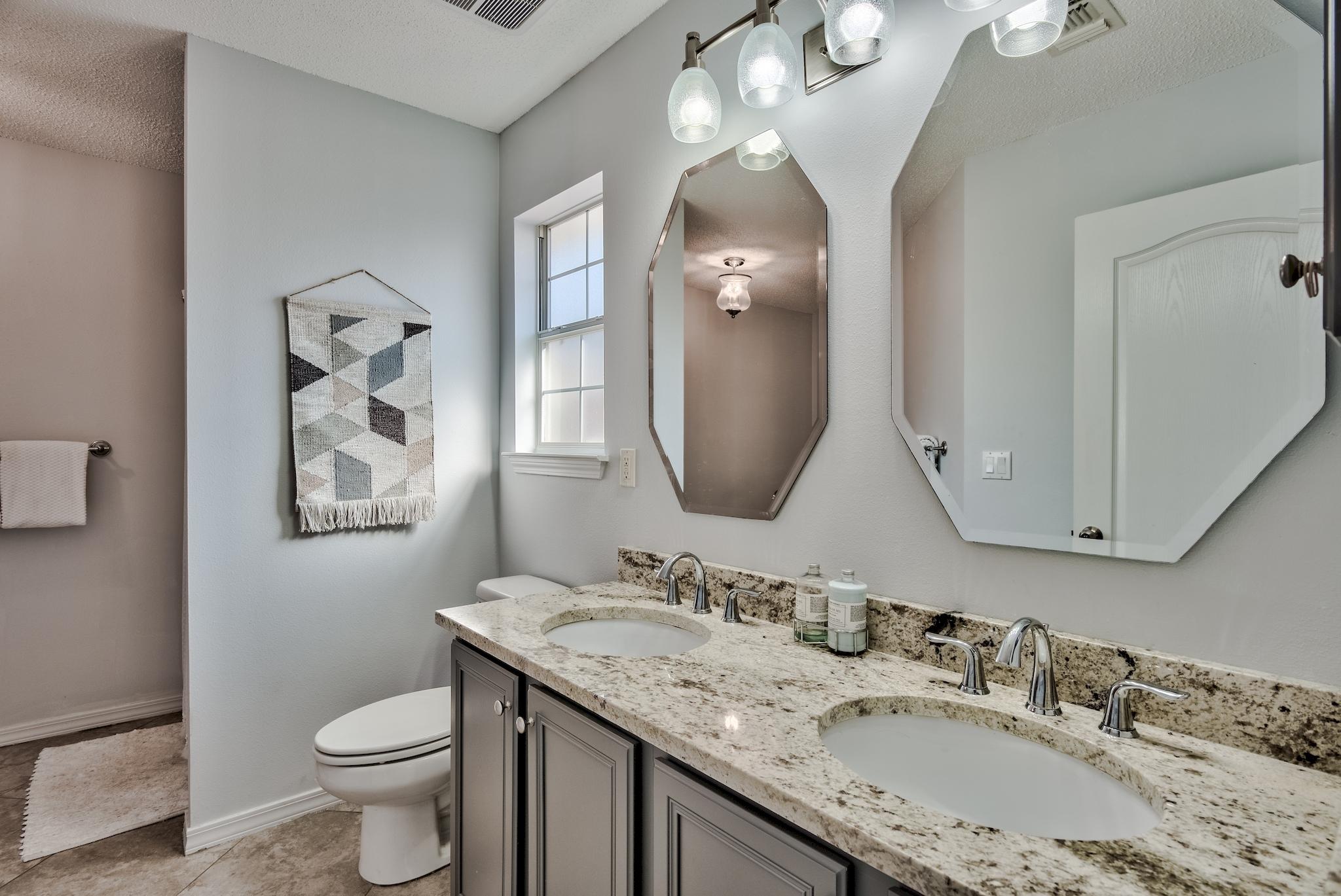 14 East Poplar Way Santa Rosa Beach, FL 32459 - Photo 17 of 30 a bathroom with a granite countertop toilet a sink and a mirror