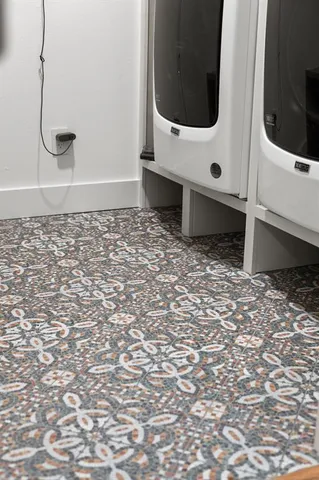 a living room with a bed furniture and a large window