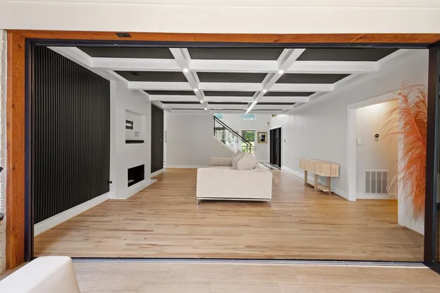 a bedroom with furniture and wooden floor