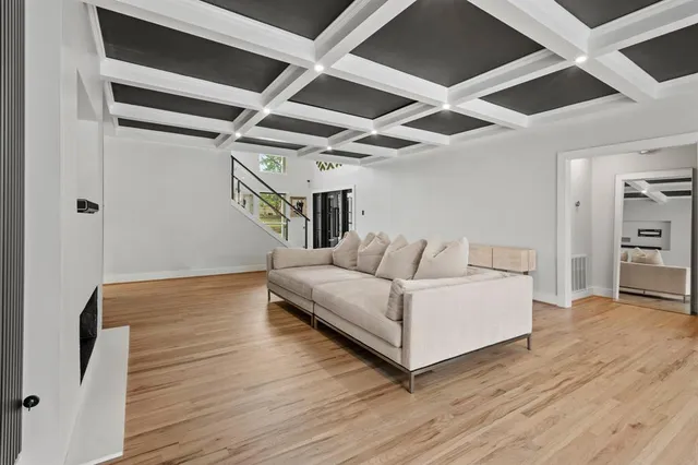 a living room with furniture and a floor to ceiling window