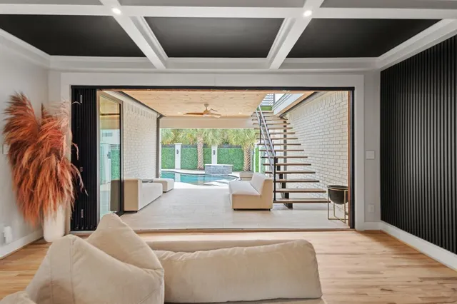 a large white bed in a large room with wooden floor