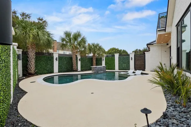 a view of a house with swimming pool and sitting area