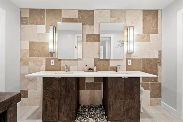 a bathroom with a sink a shower and a mirror