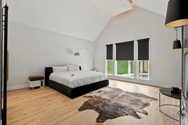 a bedroom with a bed and a large mirror