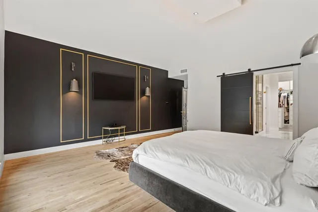 a large en suite bathroom with a granite countertop double vanity sink a mirror and shower