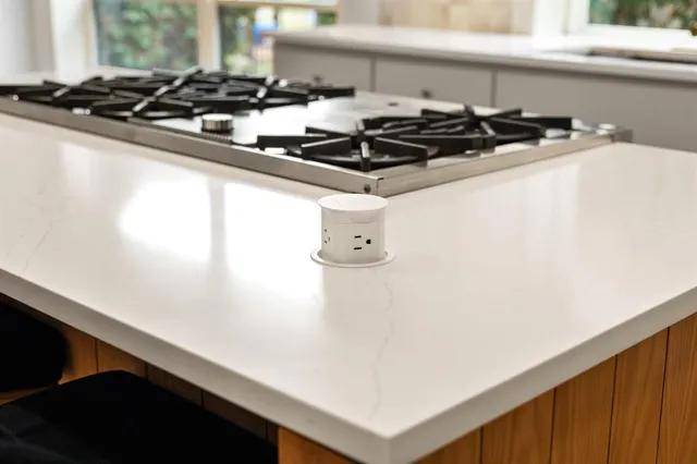 a close up of a stove top oven sitting inside of a counter