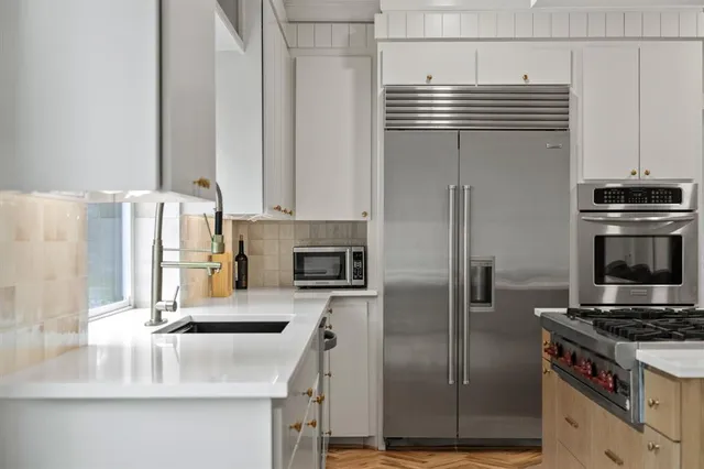 a kitchen with a stove a sink and a refrigerator