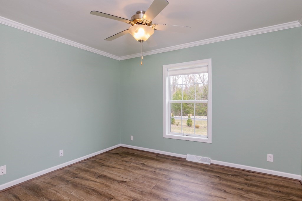 102 Topaz Terrace Gardner, MA 01440 - Photo 12 of 20 a view of an empty room with window and wooden floor