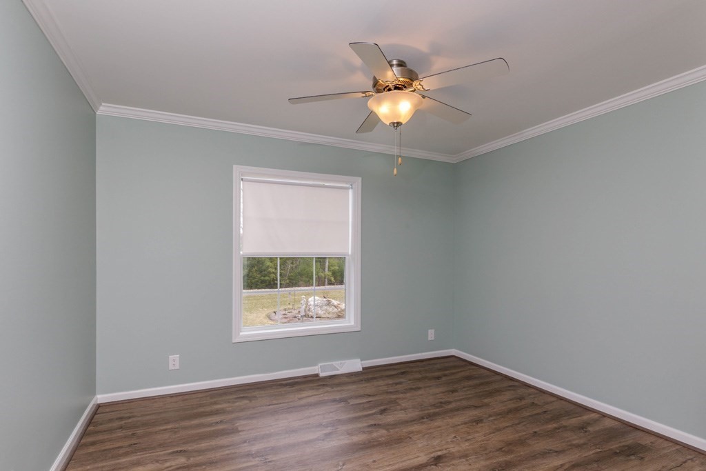 102 Topaz Terrace Gardner, MA 01440 - Photo 13 of 20 an empty room with wooden floor fan and windows