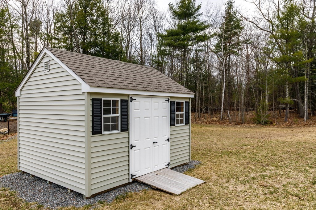 102 Topaz Terrace Gardner, MA 01440 - Photo 17 of 20 a view of a white house with a small yard and large trees