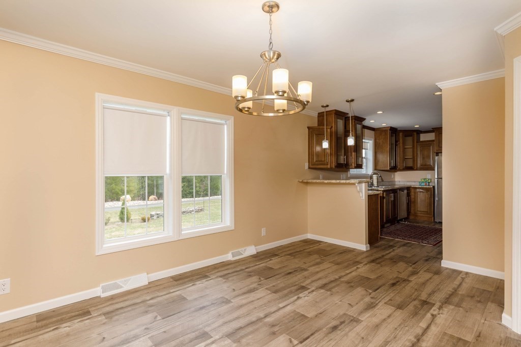 102 Topaz Terrace Gardner, MA 01440 - Photo 4 of 20 a view of a kitchen with a stove cabinets and wooden floor