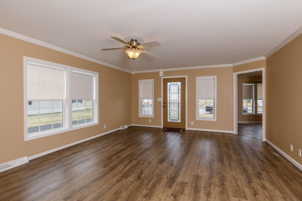 102 Topaz Terrace Gardner, MA 01440 - Photo 6 of 20 a view of an empty room with a window and wooden floor
