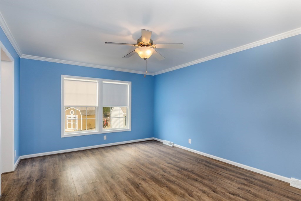 102 Topaz Terrace Gardner, MA 01440 - Photo 8 of 20 an empty room with wooden floor chandelier fan and windows