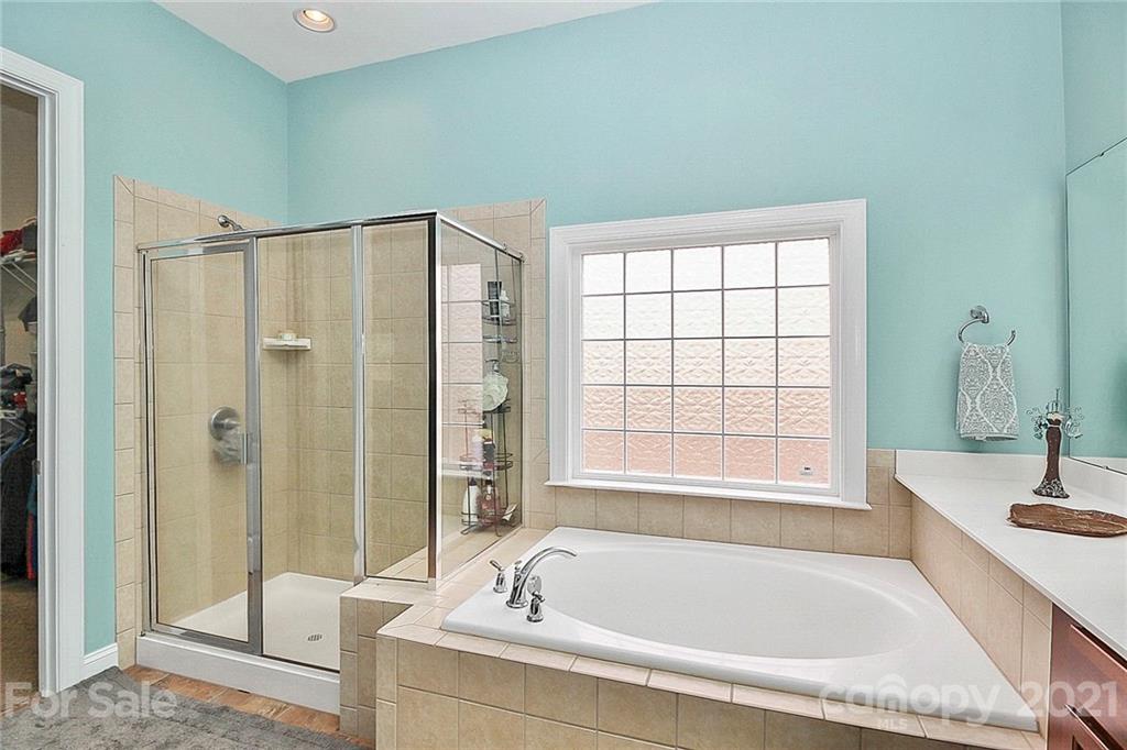 1339 Secret Path Drive Fort Mill, SC 29708 - Photo 16 of 46 a bathroom with a tub sink and mirror