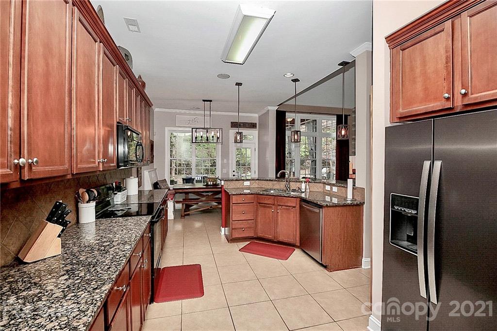 1339 Secret Path Drive Fort Mill, SC 29708 - Photo 26 of 46 a kitchen with granite countertop stainless steel appliances a sink dishwasher stove top oven refrigerator and cabinets