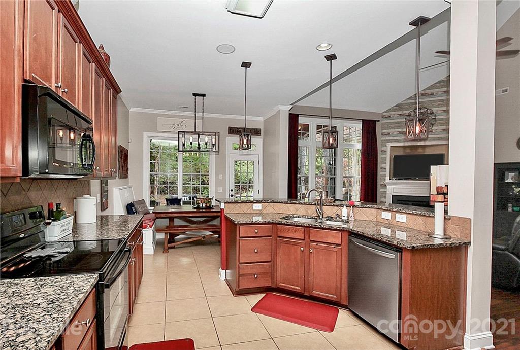 1339 Secret Path Drive Fort Mill, SC 29708 - Photo 27 of 46 a kitchen with stainless steel appliances granite countertop a refrigerator a stove and a sink with cabinets