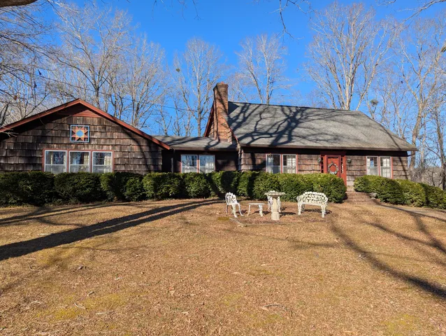 a view of a patio with a table and chairs under an umbrella