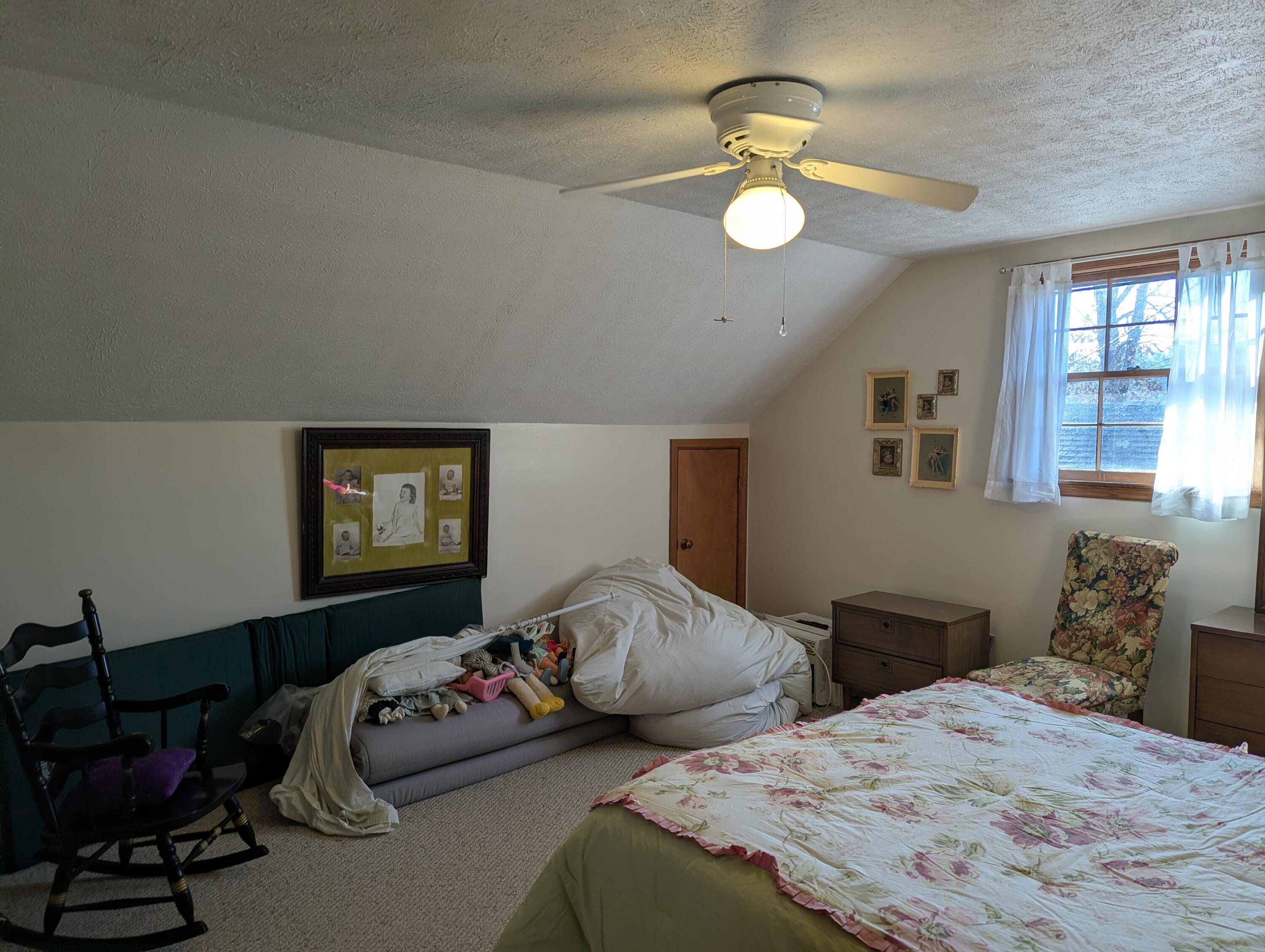 1115 Robin Ridge Road Henry, VA 24102 - Photo 12 of 59 a bedroom with bed and a chandelier