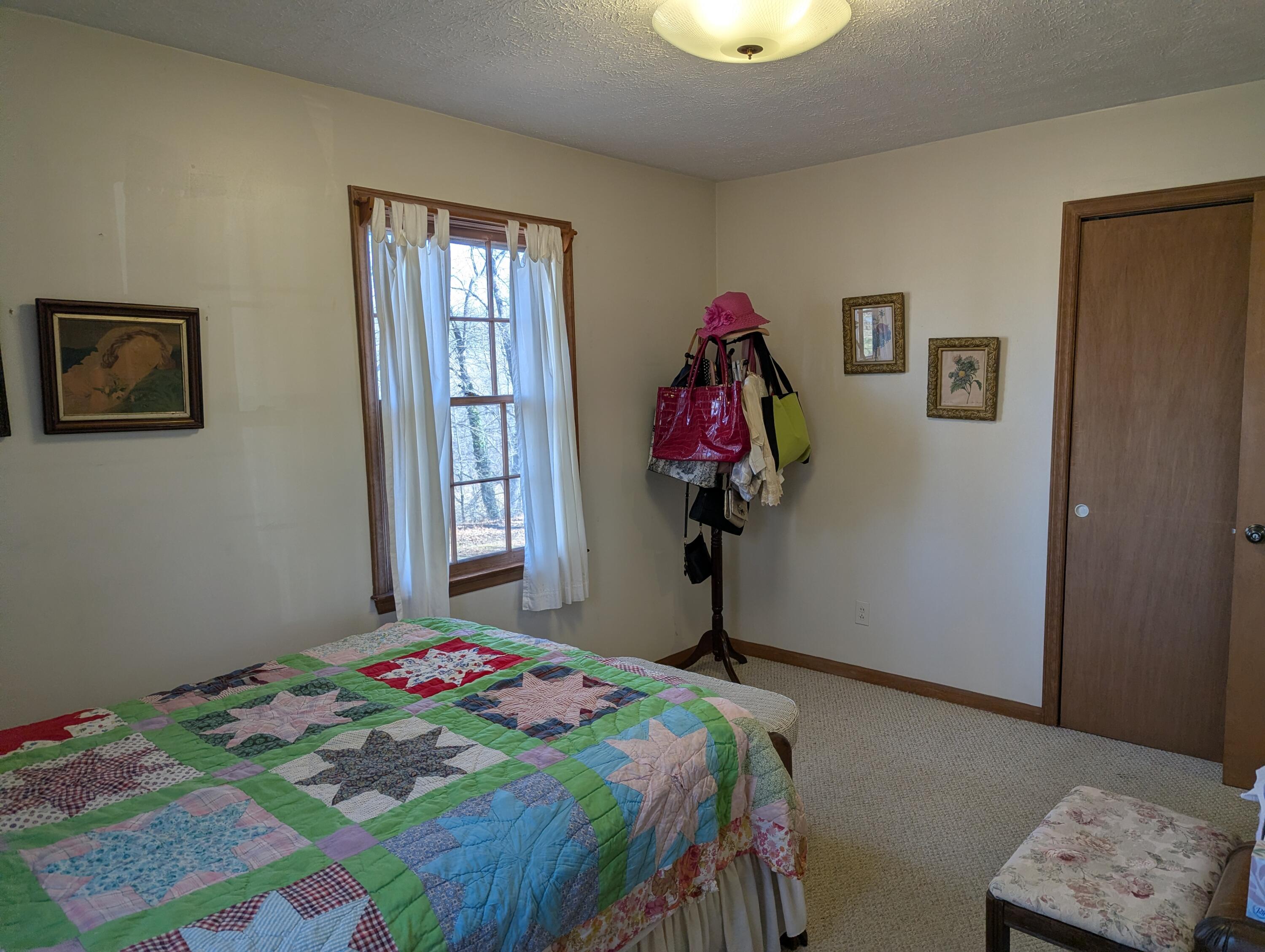 1115 Robin Ridge Road Henry, VA 24102 - Photo 19 of 59 a bedroom with a bed and a window