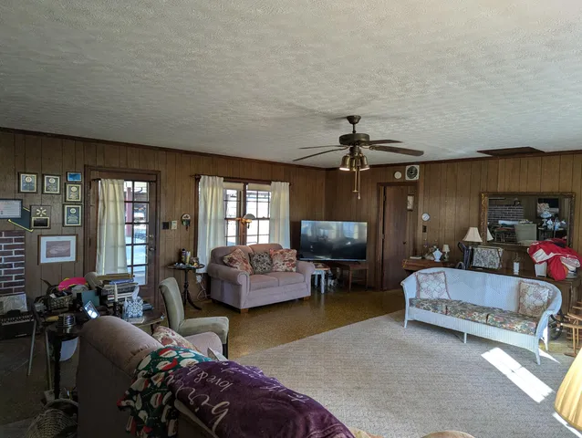 a living room with furniture and a chandelier