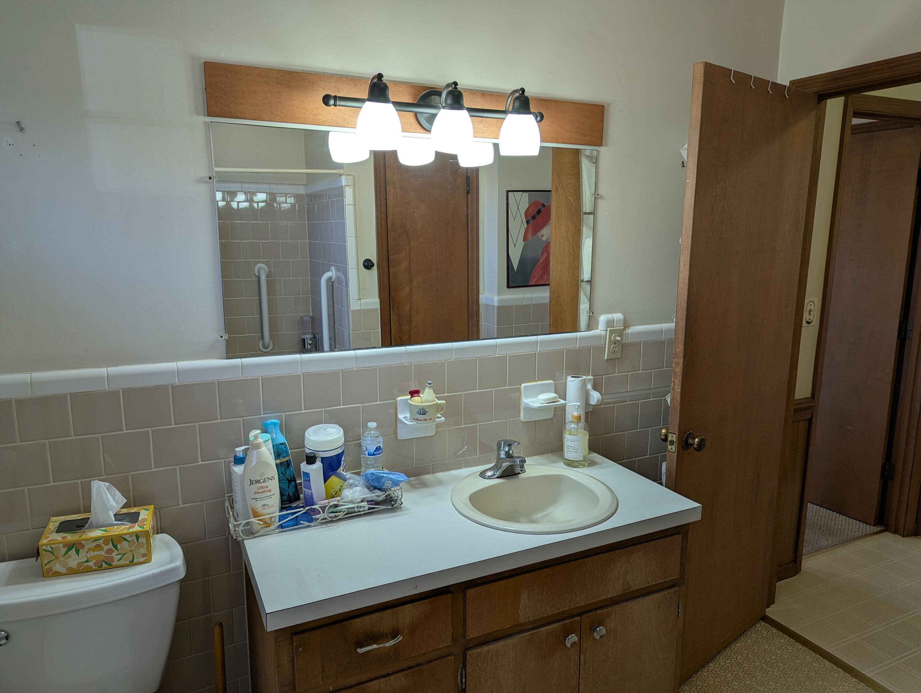 1115 Robin Ridge Road Henry, VA 24102 - Photo 21 of 59 a bathroom with a sink vanity granite and a mirror