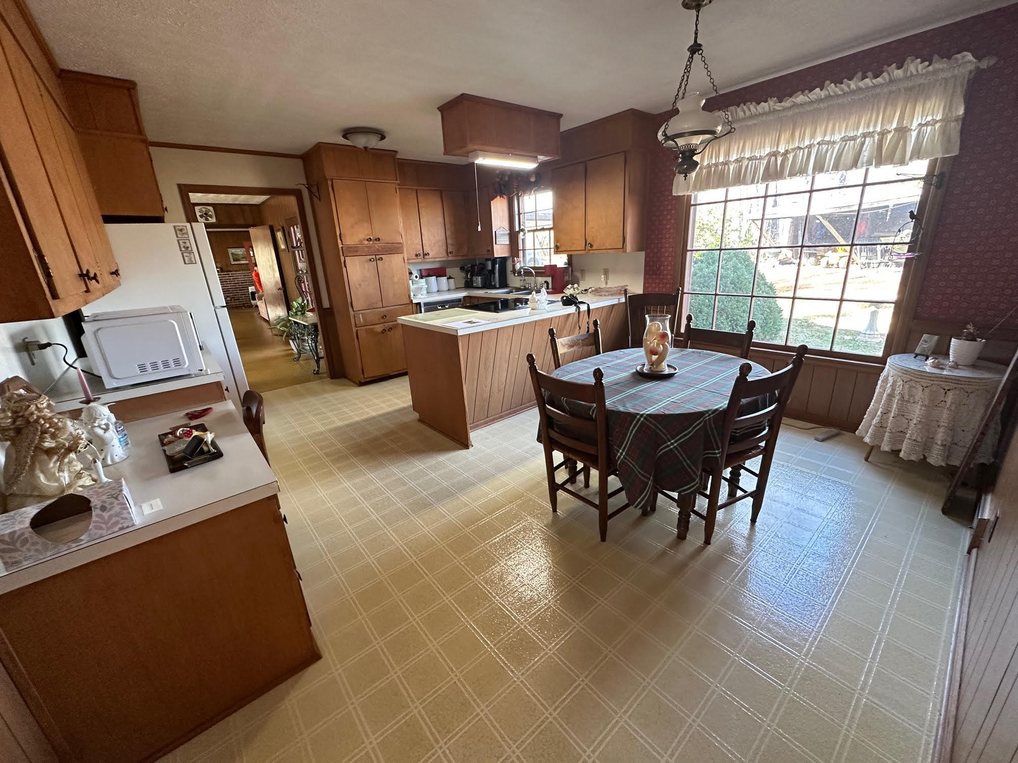 1115 Robin Ridge Road Henry, VA 24102 - Photo 52 of 59 a kitchen with a refrigerator a stove a dining table and chairs with wooden floor