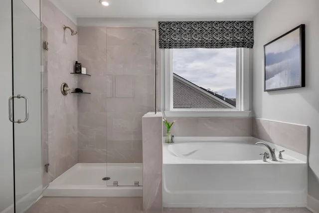 a bathroom with a bathtub and a shower