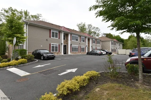 a street view with couple of cars parked on road