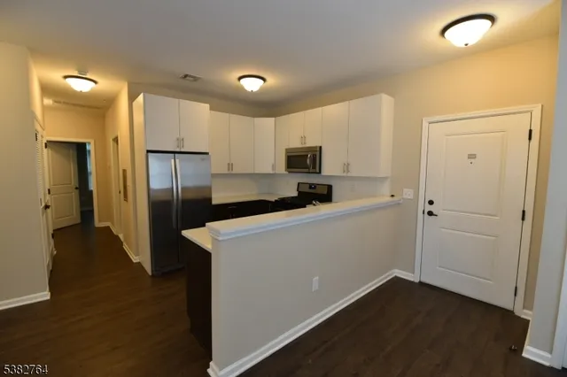 a kitchen with a refrigerator a sink and cabinets